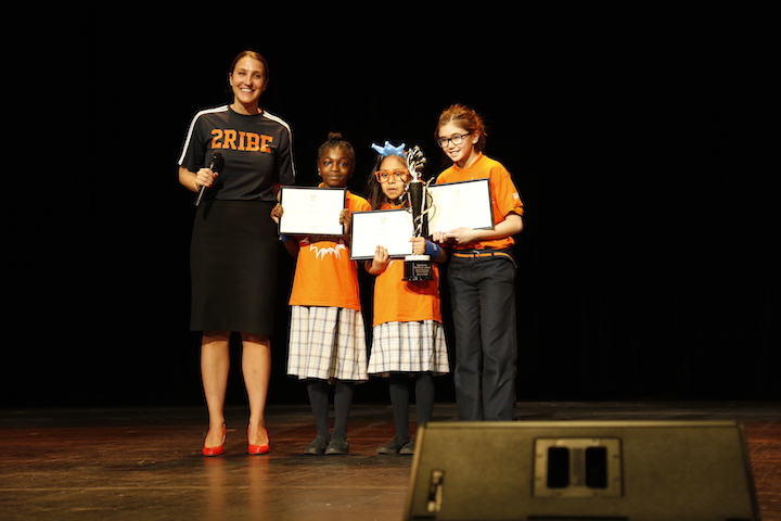 Ms. Mackall, Principal of Success Academy Harlem 2, presents the Math Excellence Award to three scholars: Gloria Aka, Fourth Grader at SA Harlem 3 Upper, Marlen Vargas, Fourth Grader at Harlem 1, and Olivia Naporano, Fourth Grader at SA Upper West. For the first time in SA history, all three of these scholars tied for first place, achieving the highest level on Math assessments.