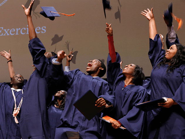 Donate to Sucess Academy - Graduating scholars throwing caps in the air