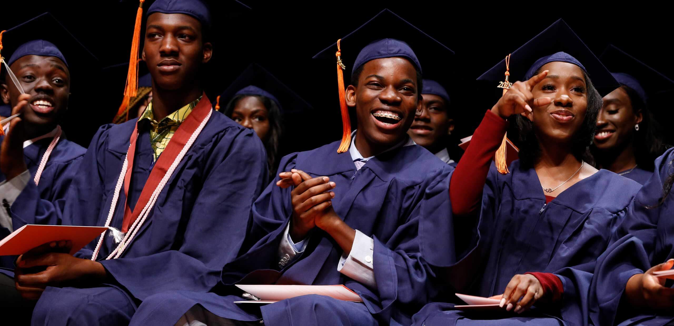 students smiling at graduation