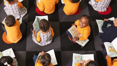 charter school students reading on a checkered mat