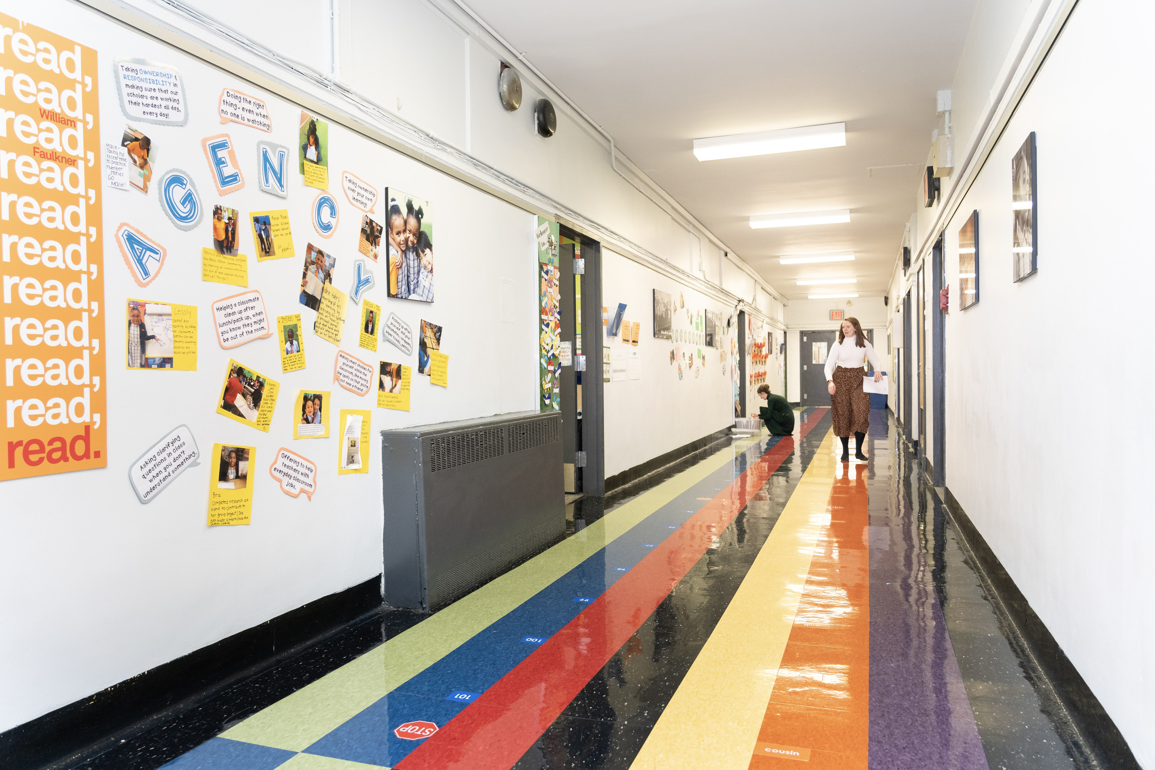 teacher walking down a school hallway