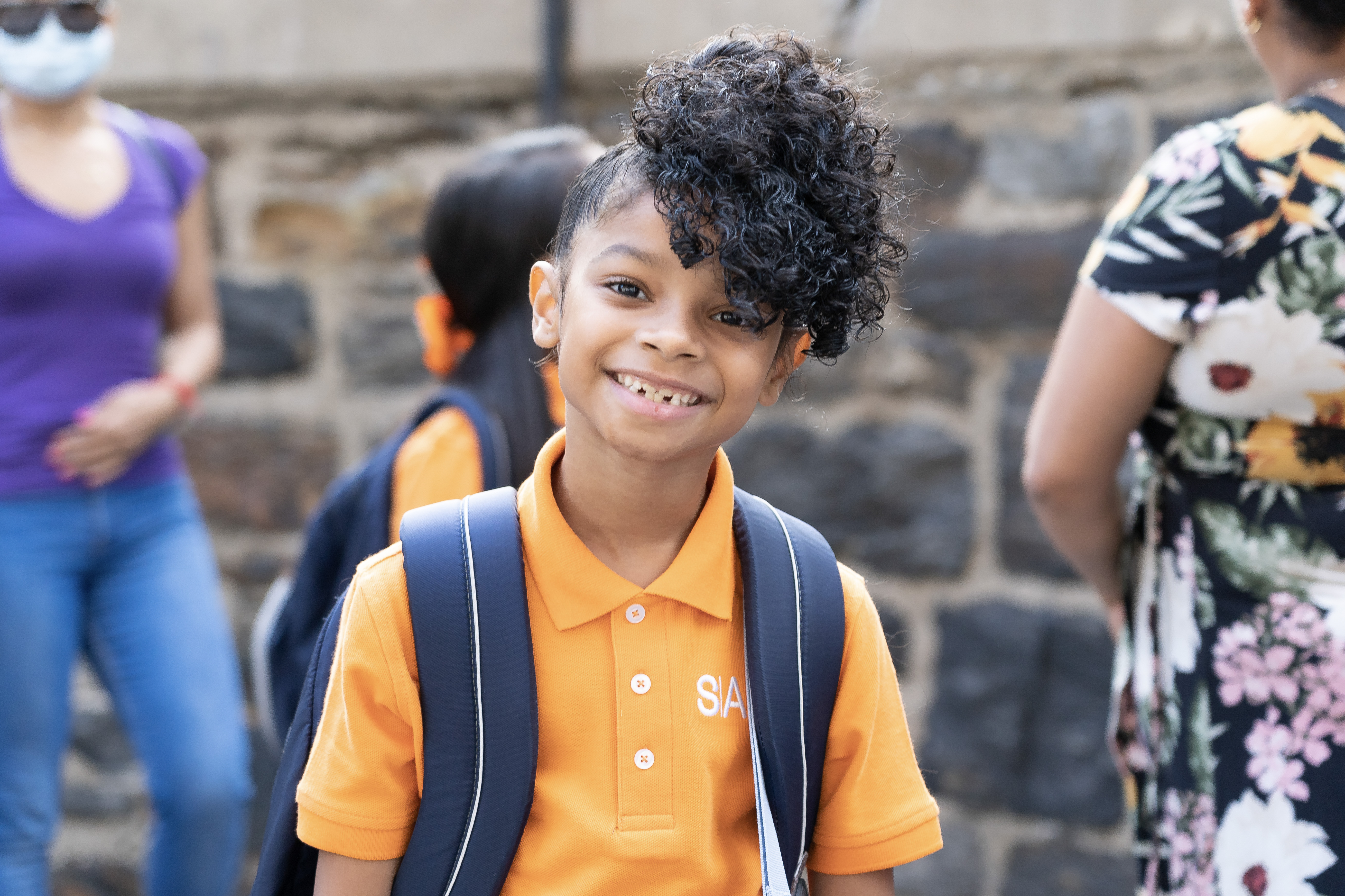 student smiling with backpack on 