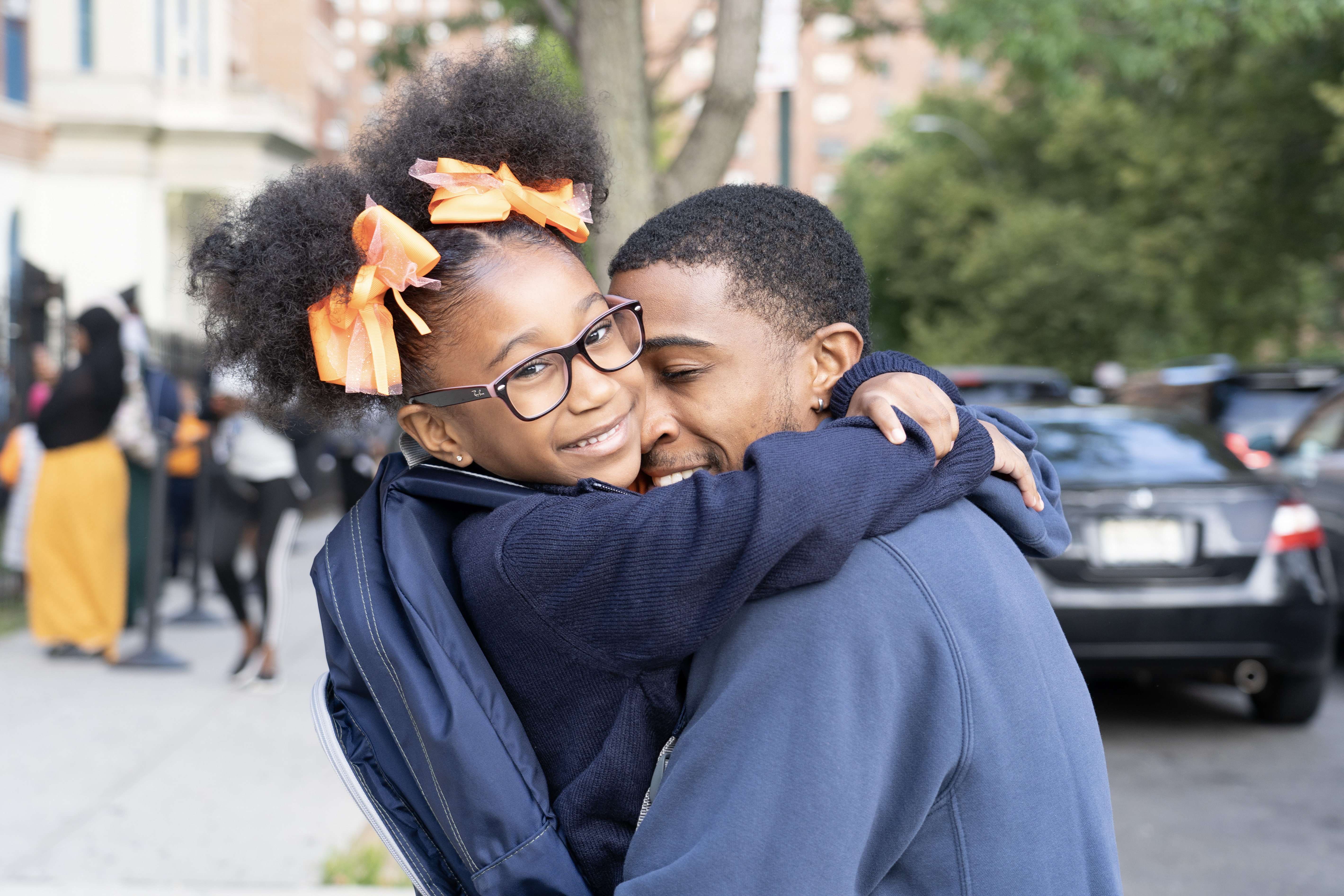 A student hugging their parent